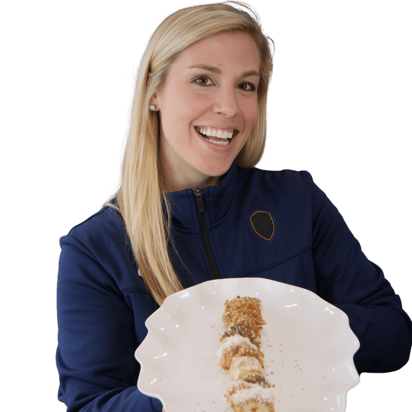 Woman presenting sushi platter in navy blue jacket.