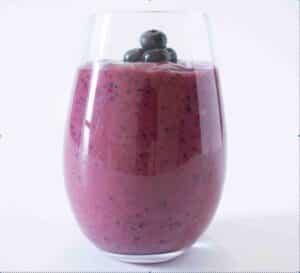 Glass of a Berry-Licious Blast AIP breakfast smoothie.