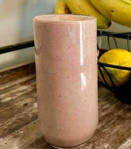 Glass of an strawberry pineapple AIP breakfast smoothie.